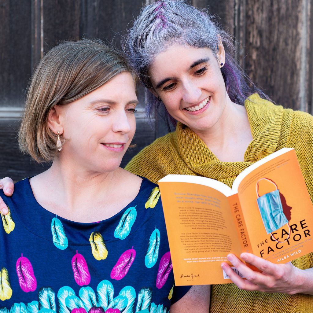 Ailsa Wilde and Simone Sheridan reading a book together.