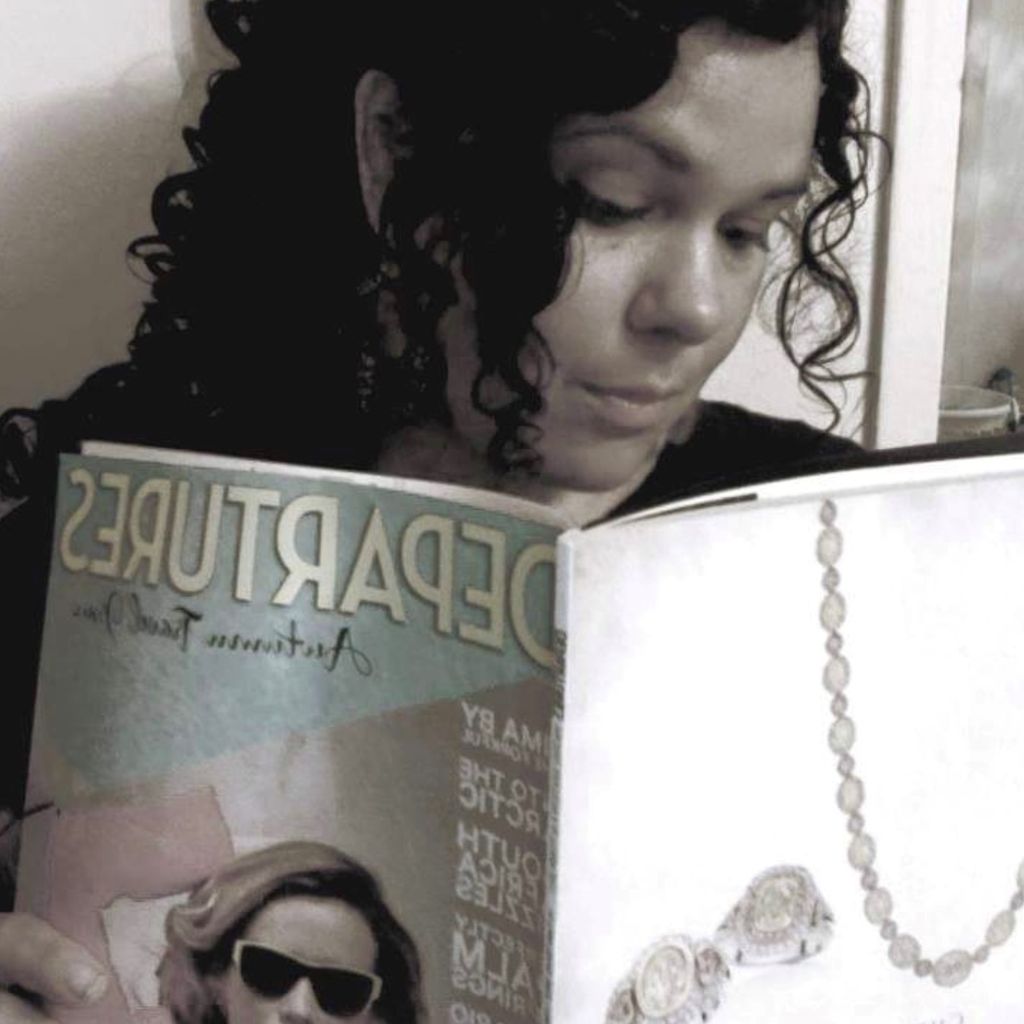 Nicole Brimmer reading a magazine titled "departures"