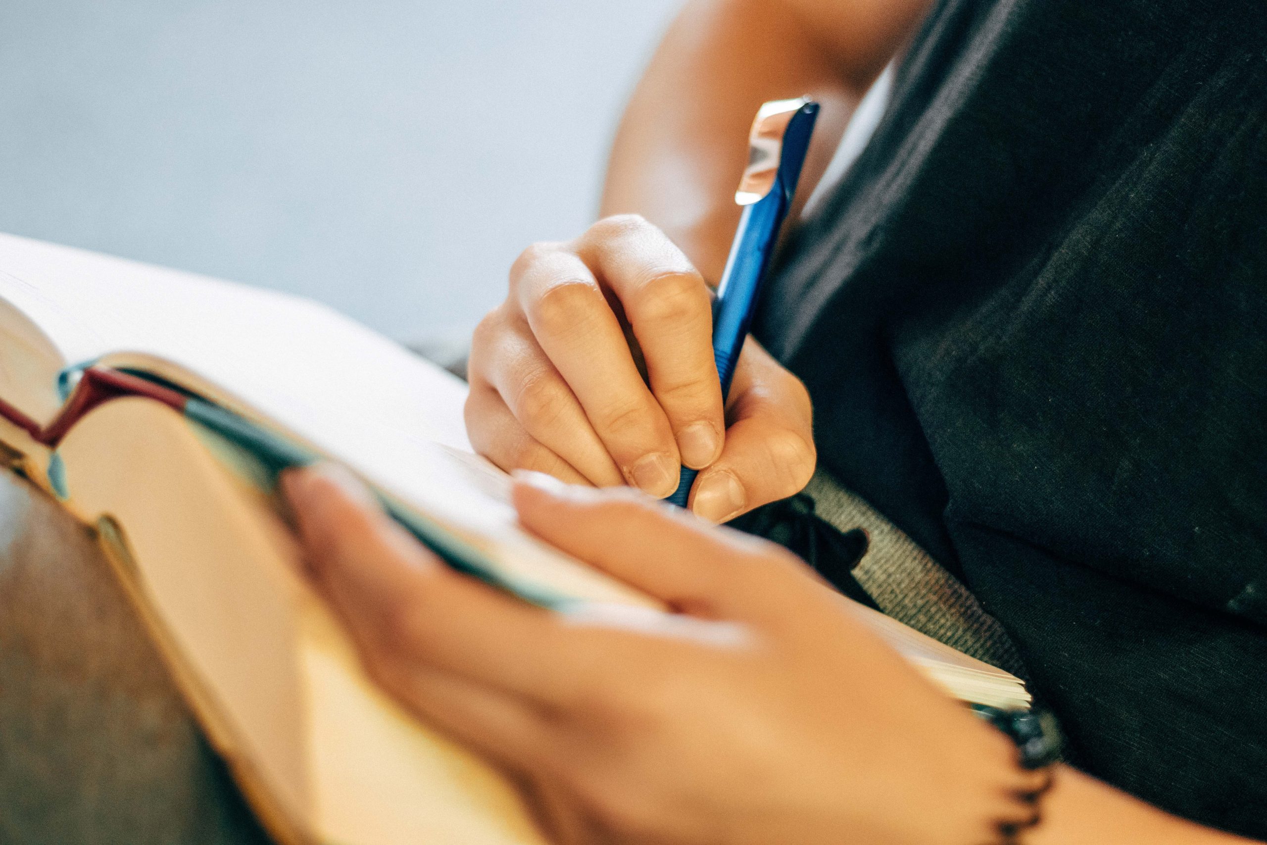 An image of a hand writing in a notebook