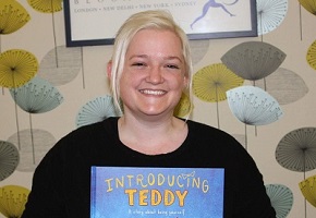 A photo of Jessica Walton holding Introducing Teddy.