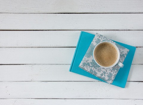 Photo of a cup of coffee on a notebook